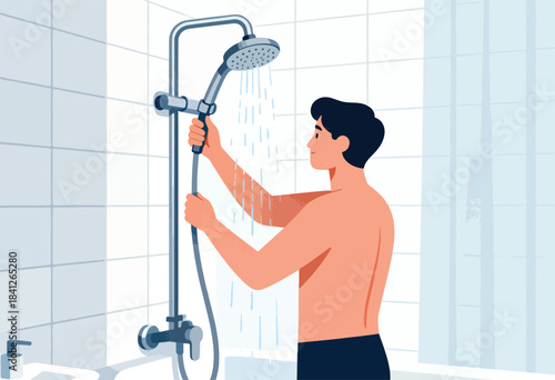 Man holding shower head with water running in tiled bathroom