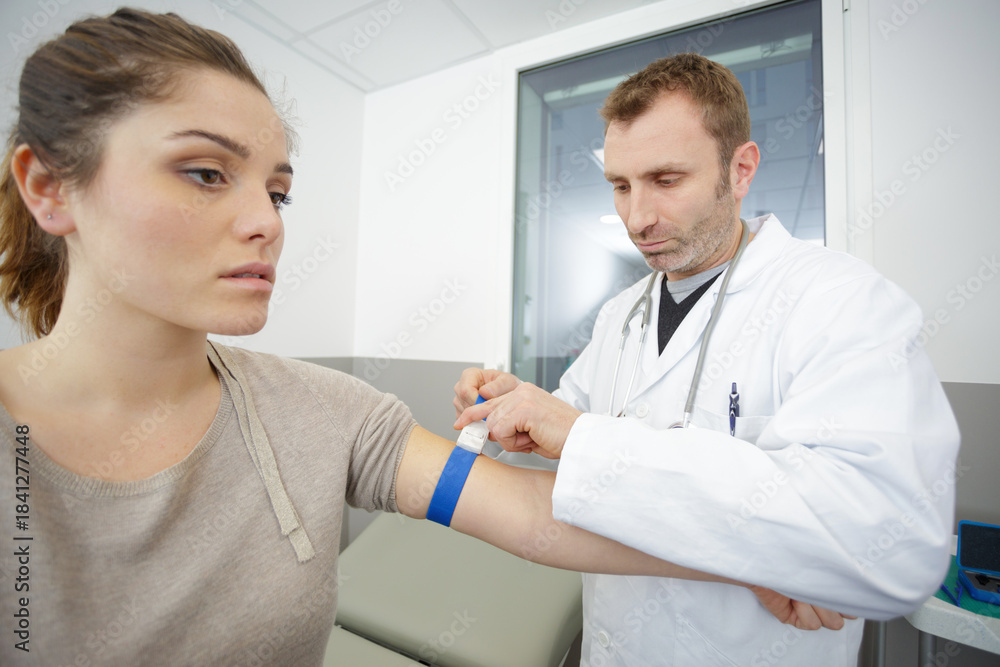Fototapeta premium doctor checking blood pressure to a patient in the hospital