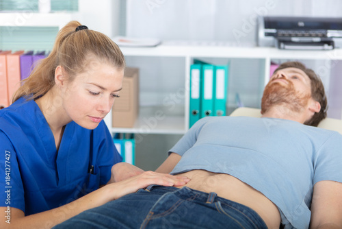 the doctor examines the patient