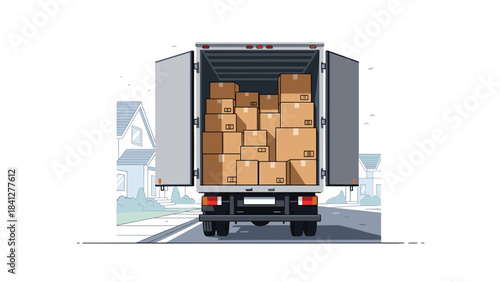 A large truck loaded with many cardboard boxes driving down a suburban street with houses on either side