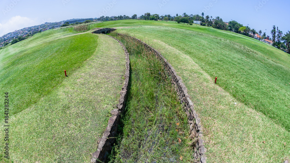 Naklejka premium Golf Course Water Weir Hazard Fairways Overlooking Green Summer Landscape