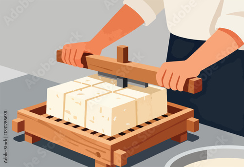 Hands pressing a large block of tofu with a wooden tool, cutting it into cubes