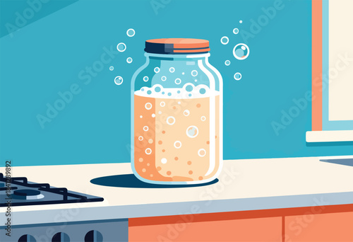 A glass jar filled with bubbling orange liquid sits on a kitchen counter beside a stove