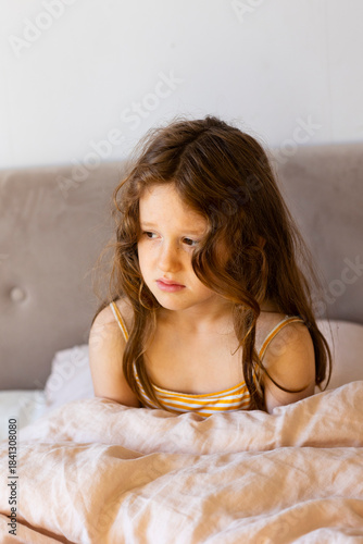 Wallpaper Mural Sad girl sitting on bed at home Torontodigital.ca