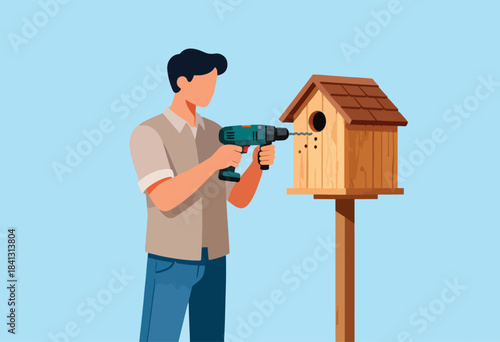 Man uses drill to assemble a wooden birdhouse on a stand