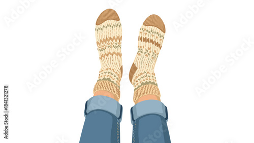 A persons feet wearing blue jeans and beige knitted socks isolated on white background with brown toe caps and cuffs