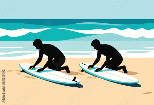 Two surfers on a beach applying wax to their boards