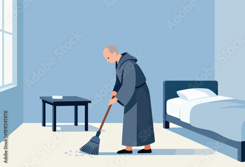 A person in a robe sweeps the floor next to a simple bed and table
