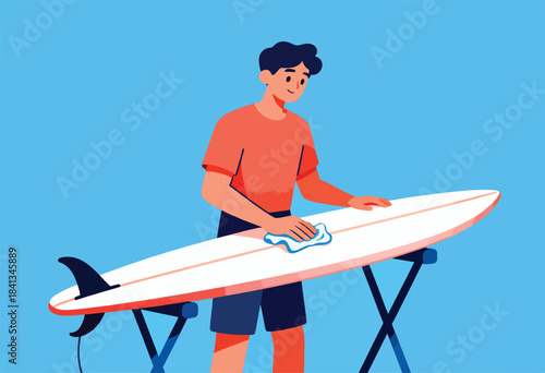 Person cleaning a white surfboard on a stand