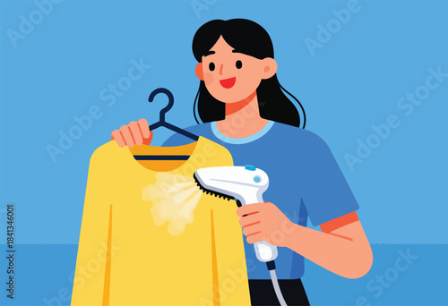 Woman uses handheld steamer to remove wrinkles from a yellow garment on a hanger