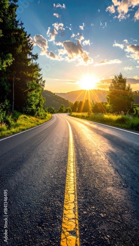 Winding country road bathed in the golden light of a bright sunset.