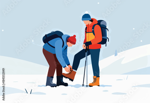 Two hikers adjust gear in a snowy, winter landscape