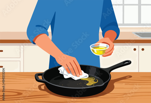 Person seasons cast iron pan with oil and cloth