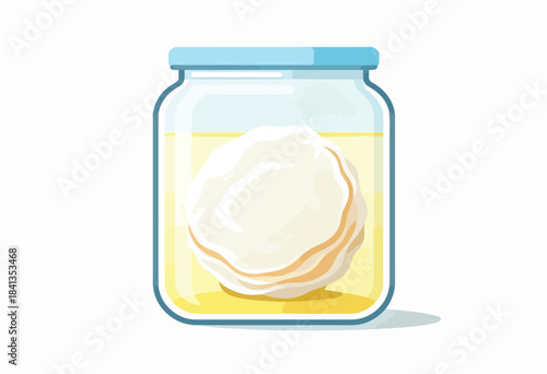 Clear jar with blue lid holding creamy white starter culture in yellow liquid