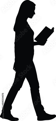 Silhouette of a woman walking while reading a book
