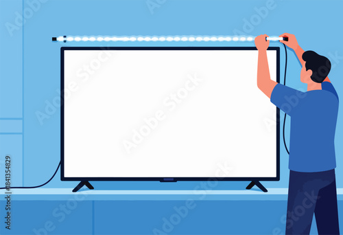 Person attaching light strip to back of television