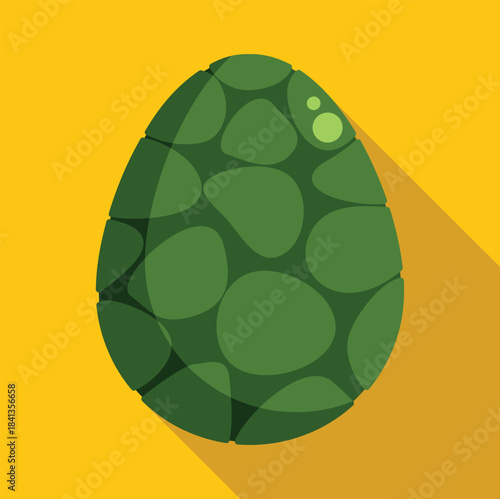 Green egg with turtle shell texture resting on a yellow surface, casting a long shadow, perfect for zoology or nature projects