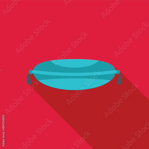 Comfortable turquoise rectangular pillow with tassels isolated on a vibrant red background, providing a modern and stylish accent for home decor