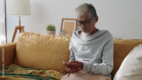 Elderly. Asian man gray hair physical therapy with finger massage, stretching for aches pains at home