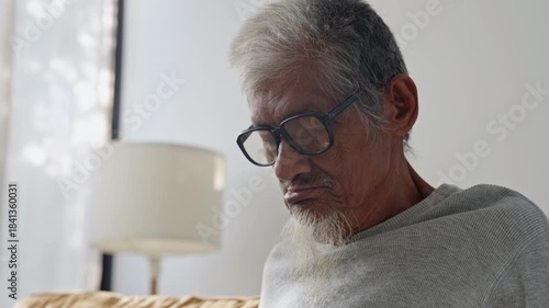 Close-up.Face elderly asian man physical therapy with finger massage, stretching for aches pains at home