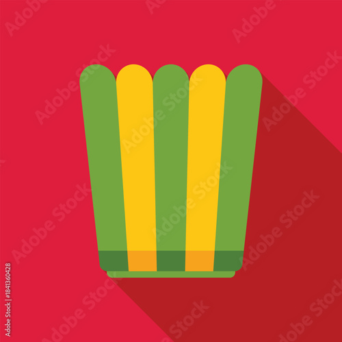Vertical striped popcorn bucket with long shadow on red background