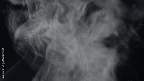 White natural rising steam from food or hot drink isolated on a black background.