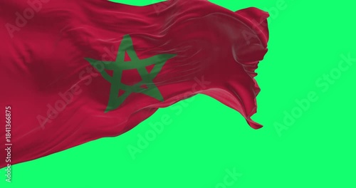 Morocco national flag waving in the wind isolated on green background