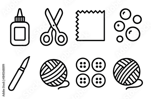 Craft tools and materials: glue, scissors, yarn, buttons, cutting blade, and fabric on dark background