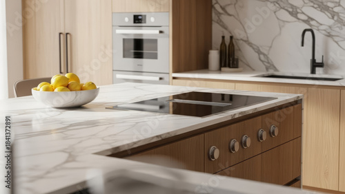 Elegant white marble kitchen island featuring induction cooktop and control knobs on wood cabinetry