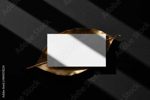 Blank White Card Mockup on Glittering Gold Leaf with Shadow Lines on Black Background