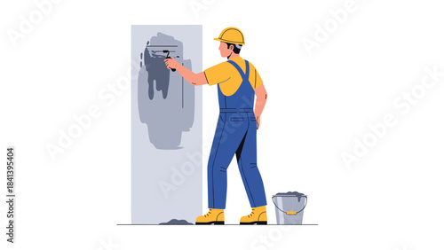 Man in blue overalls painting a wall with a roller and bucket beside him