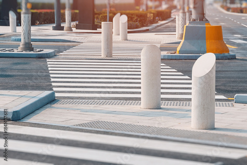 Photos Modern urban crosswalk with white stripes and pedestrian bollards