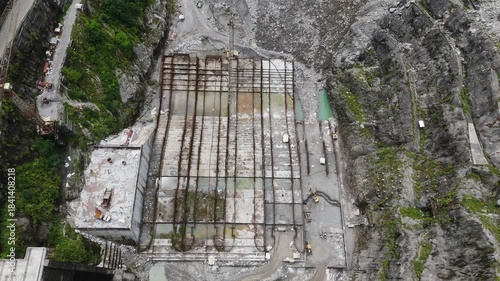 Detailed overhead view of steel reinforcement bars and concrete structures at a dam construction site, showcasing the engineering scale of Nepal's energy sector development and growth