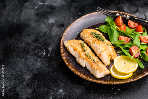 Photography Roast Cod fish fiilets, white fish meat on plate with salad