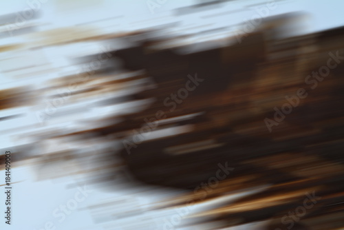 Brown tree trunk or landscape motion blur creating dynamic horizontal abstract streaks.