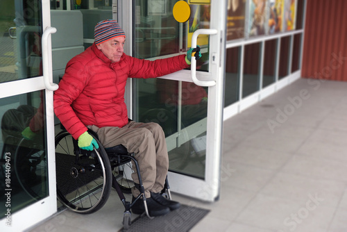 A man in a wheelchair walks out of a door