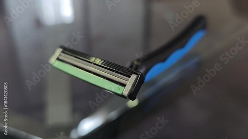 Sharp Triple-Blade Shaver on Reflective Surface - Men's Personal Care