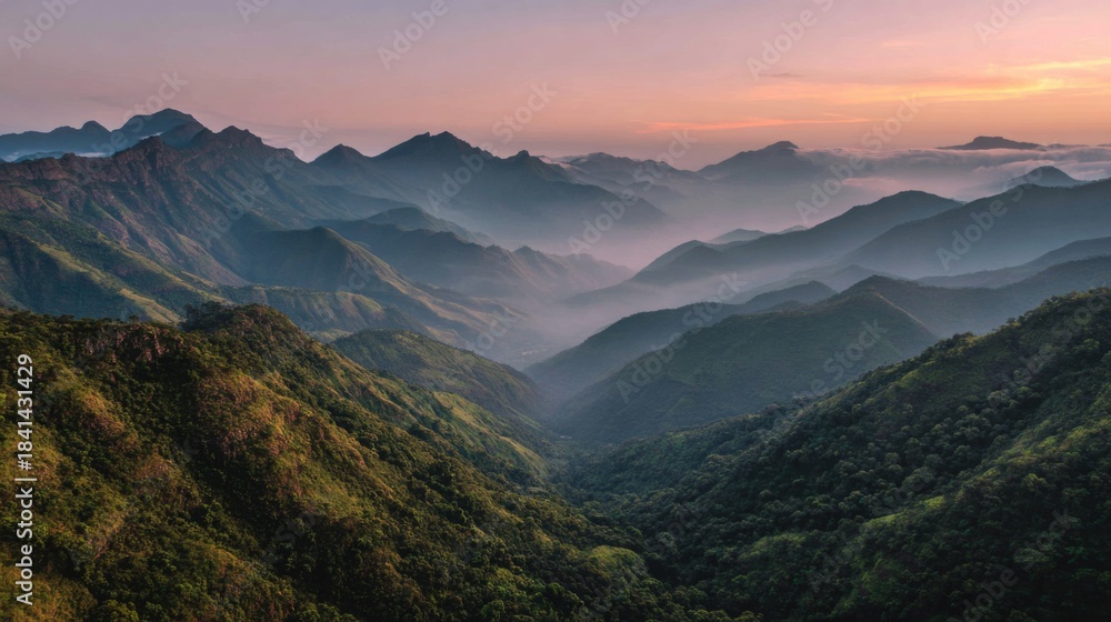 Obraz premium Breathtaking Sunrise Over Lush Mountain Range with Fog Covering Valleys and Peaks Illuminated by Warm Morning Light