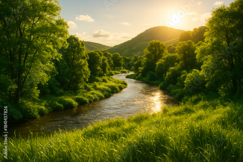 Scenic landscape of winding river flowing through lush green valley forest at golden sunset.