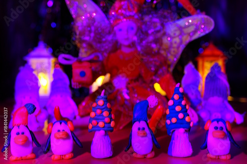 Fabulous decorations and toys: penguins, fairy, gnomes and Christmas lanterns. Purple shade.