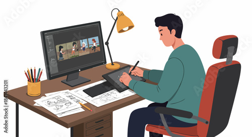 Young male animator or graphic designer working at his desk, creating digital art and storyboards using a tablet and computer, in a creative professional workspace.