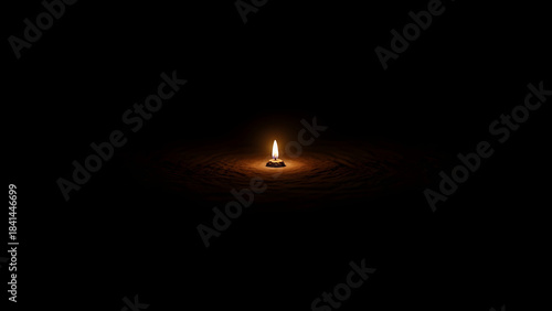 Single small candle flame burning brightly in complete darkness, representing hope, spirituality, or a vigil