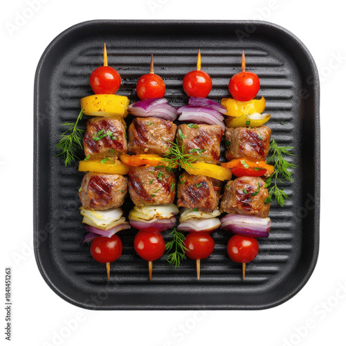 Four grilled meat and vegetable skewers on a black ridged pan