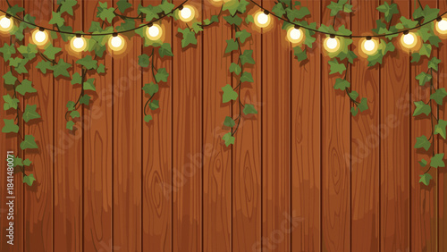 A string of lights and green leaves on a wooden fence with a warm glow at night