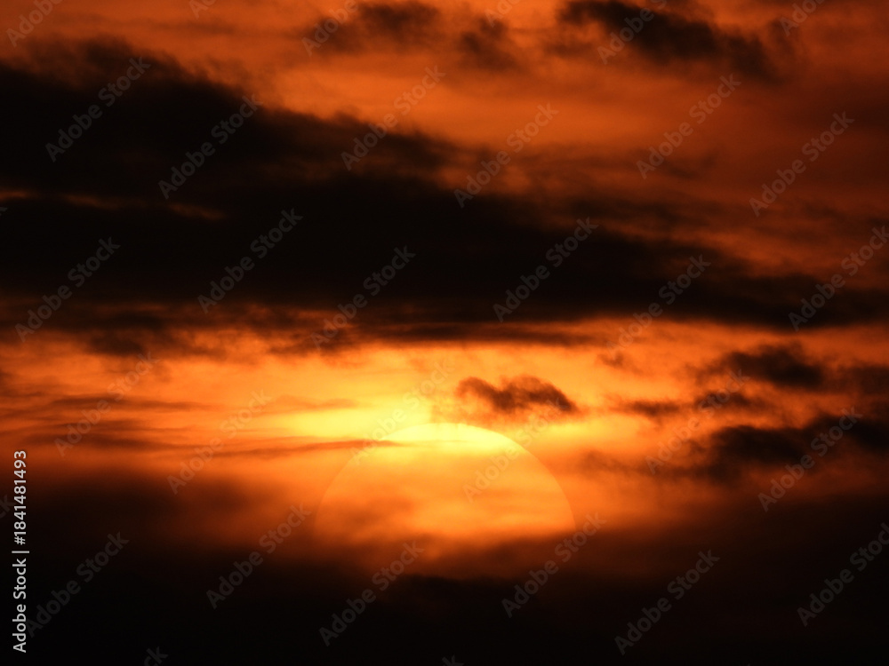 Fototapeta premium sun zoomed behind the clouds at the sunset over the Adriatic sea in Rovinj