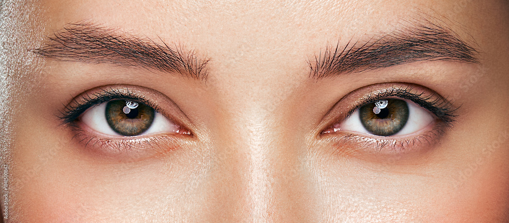 Obraz premium Beautiful female eyes with long eyelashes. Eyelash extensions. Makeup, cosmetics, beauty. Close up, macro