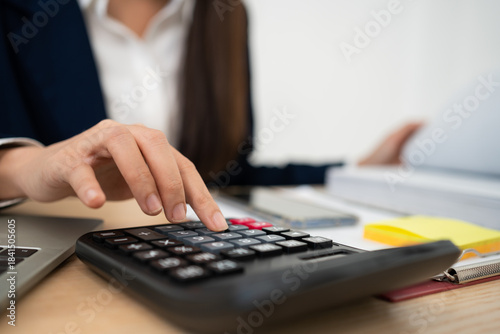 Financial Precision: A professional accountant meticulously calculates financial data, ensuring accuracy and efficiency in a focused work environment.