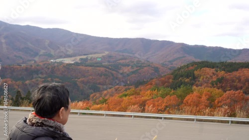 Asian senior couple road trip view autumn red trees on Gifu mountain 4k