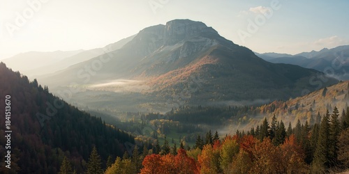 Fototapeta Naklejka Na Ścianę i Meble -  Vivid autumn mountainside scene with ridge, trees, and sunrise highlighting seasonal transition