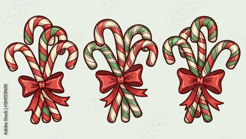Three bunches of striped red green and white candy canes tied with red bows on a plain background